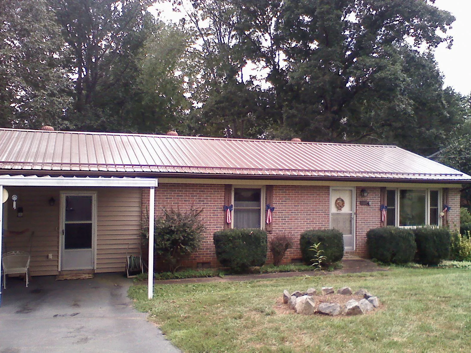 Bronze metal roof and carport on a brick ranch home — Roof Repair work by our crew in Short Hills