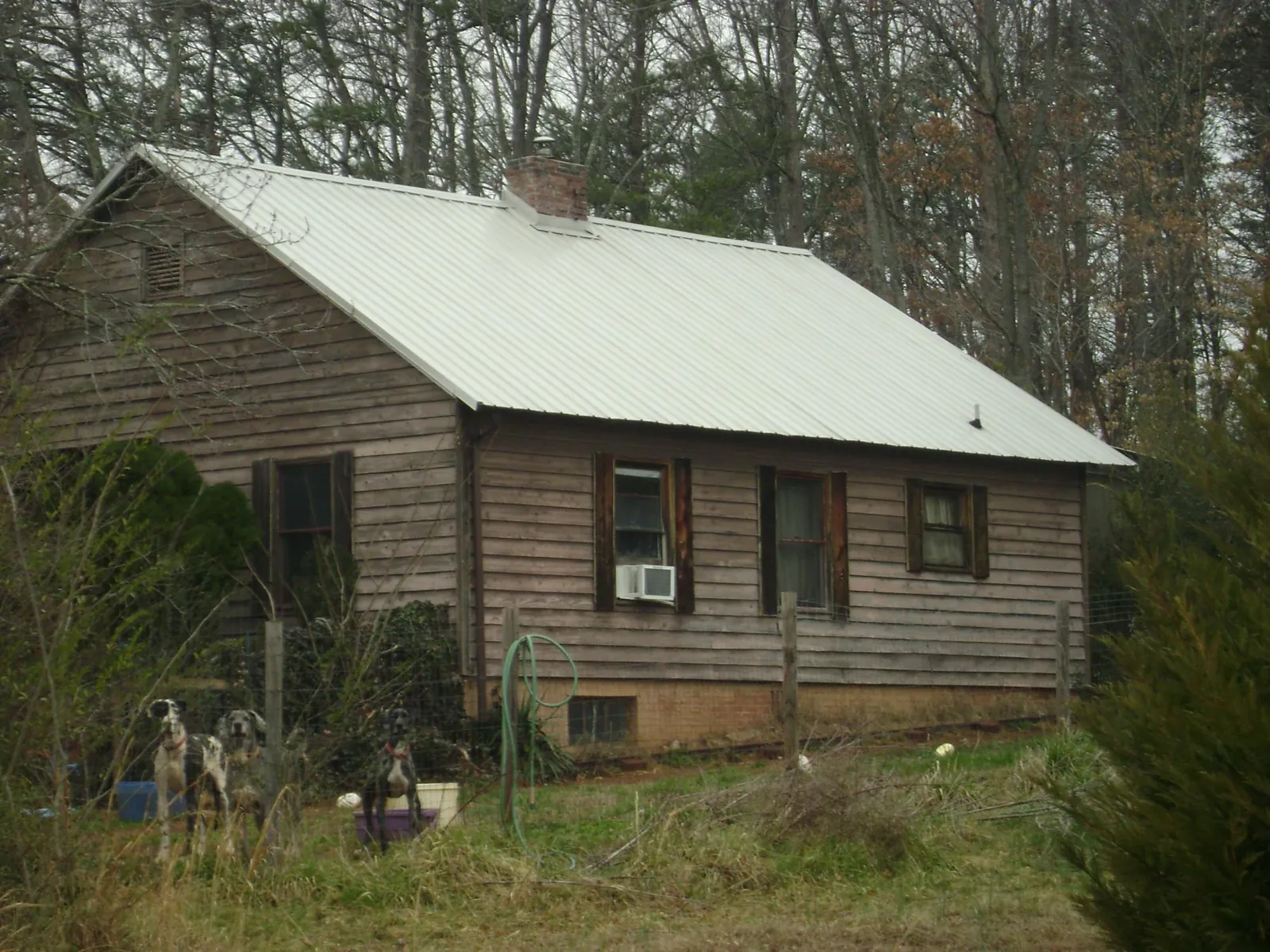 White metal roof on an old wood sided farmhouse, from a Asphalt Shingle Roof Repair job in Short Hills